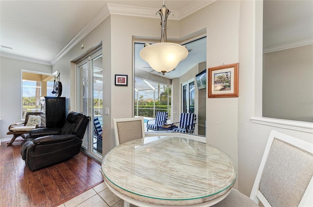 dining room with ornamental molding, a wealth of natural light, and wood finished floors