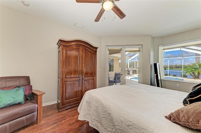 bedroom featuring access to exterior, baseboards, dark wood-style floors, and ceiling fan