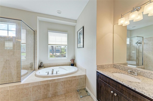 bathroom with a shower stall, vanity, a bath, and tile patterned floors