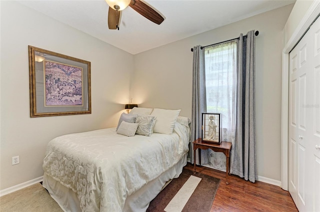 bedroom with a ceiling fan, baseboards, a closet, and wood finished floors