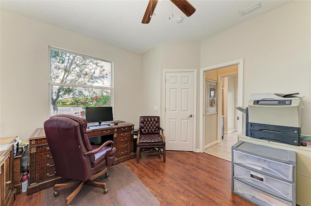 home office featuring a ceiling fan, visible vents, and wood finished floors