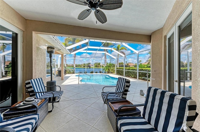 view of patio featuring an outdoor pool, a lanai, and ceiling fan