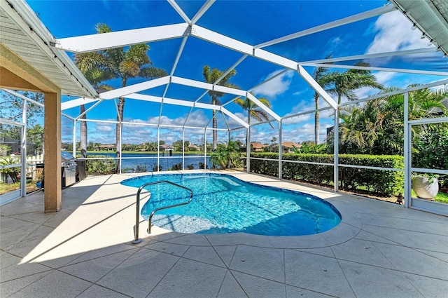 pool with glass enclosure and a patio area