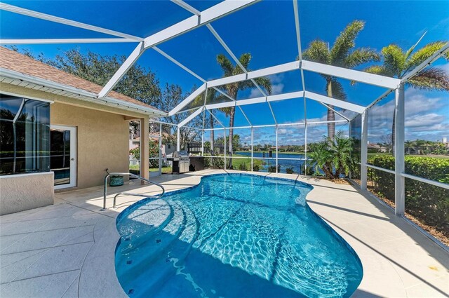 pool featuring a lanai, a patio area, and area for grilling