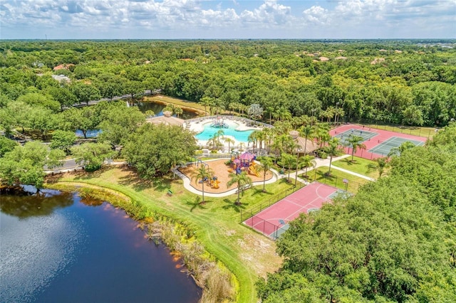 aerial view with a water view and a wooded view