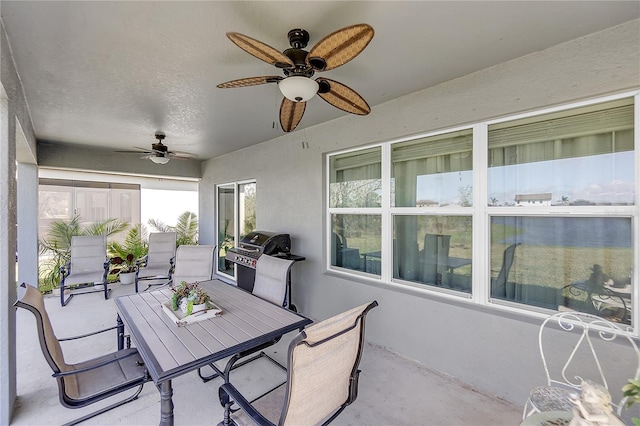 view of patio with outdoor dining area, ceiling fan, and area for grilling