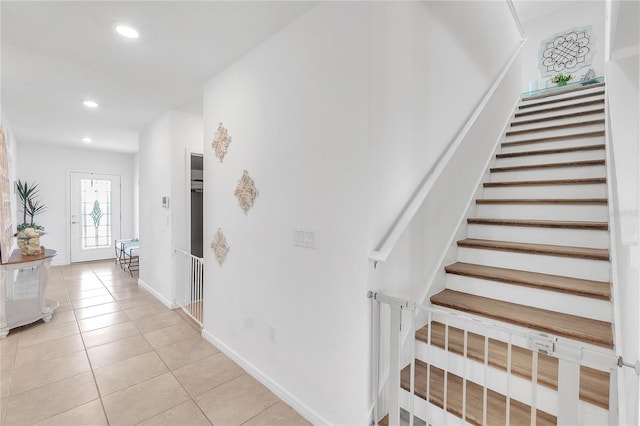 stairs with baseboards, recessed lighting, and tile patterned floors