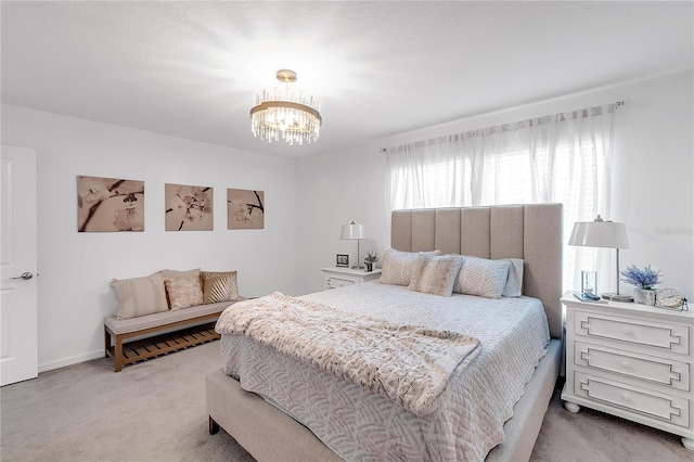 bedroom with light carpet, baseboards, and a notable chandelier