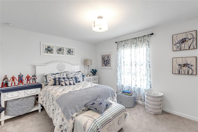 carpeted bedroom featuring baseboards