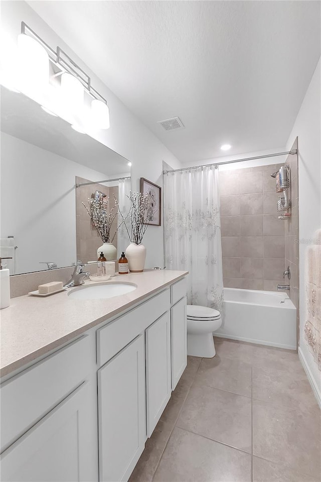 full bathroom featuring toilet, vanity, visible vents, tile patterned floors, and shower / bath combo