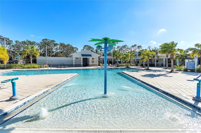 community pool with fence and a patio