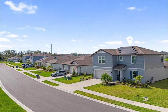 view of front facade with roof mounted solar panels, a garage, a residential view, driveway, and a front lawn