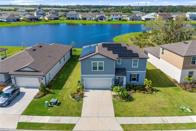 drone / aerial view with a water view and a residential view