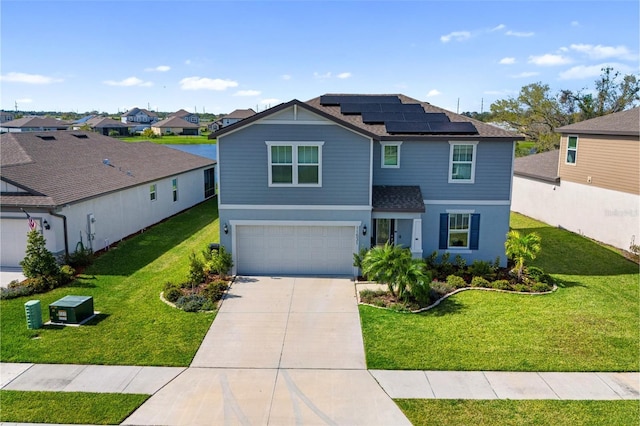 view of front of property featuring an attached garage, solar panels, driveway, a residential view, and a front lawn