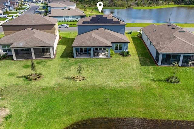 drone / aerial view with a residential view and a water view