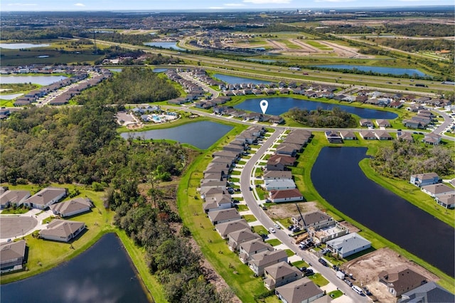 drone / aerial view with a water view and a residential view