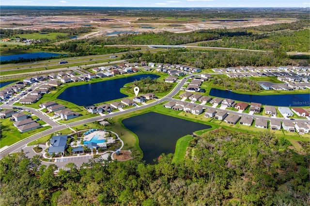 drone / aerial view featuring a water view and a residential view