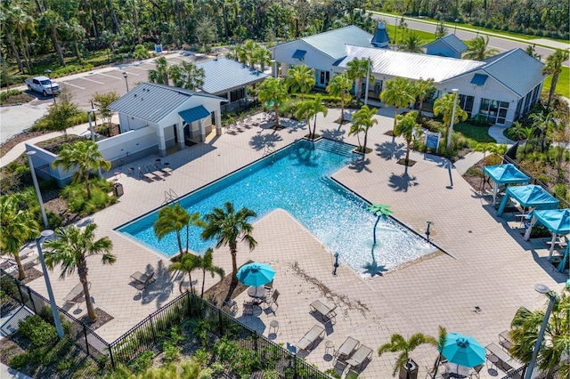 pool with a patio and fence