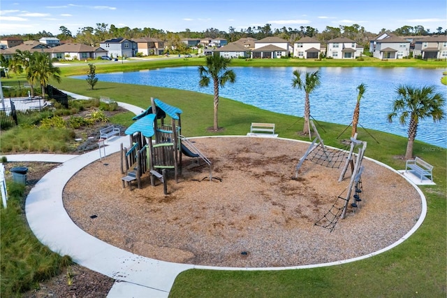 community jungle gym featuring a water view, a residential view, and a lawn