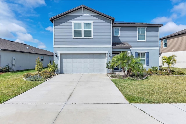 traditional-style home featuring concrete driveway, a front lawn, an attached garage, and stucco siding