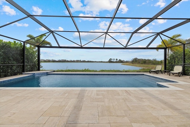 outdoor pool featuring a water view, glass enclosure, and a patio area