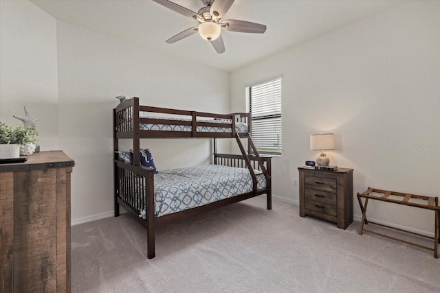 bedroom with a ceiling fan, carpet flooring, and baseboards