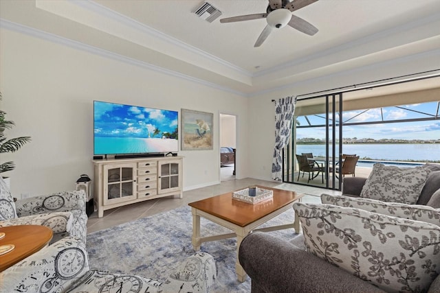 living area featuring ornamental molding, a raised ceiling, visible vents, and light tile patterned floors