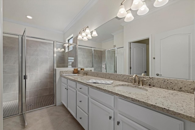 bathroom with ornamental molding, a sink, and a shower stall