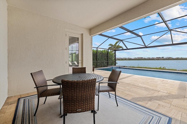 view of patio / terrace with a water view, glass enclosure, and an outdoor pool