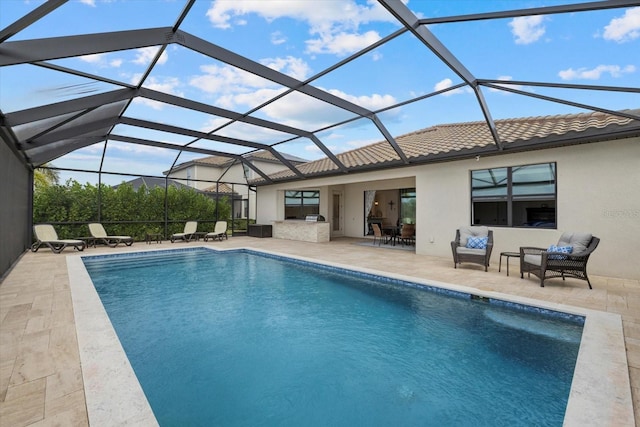 outdoor pool featuring area for grilling, a patio area, and a lanai