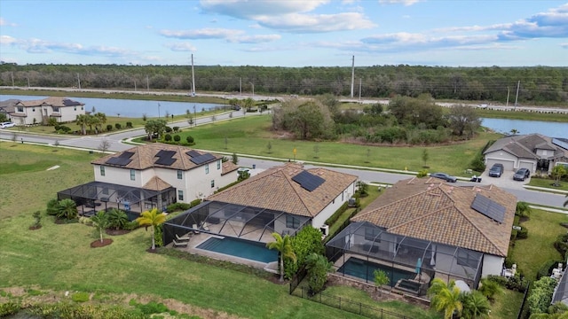 birds eye view of property with a water view and a residential view