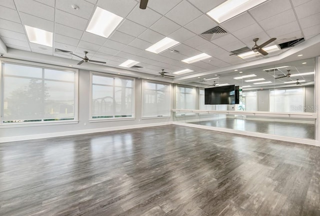 interior space with visible vents, ceiling fan, baseboards, and wood finished floors