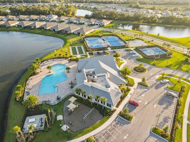 drone / aerial view featuring a residential view and a water view