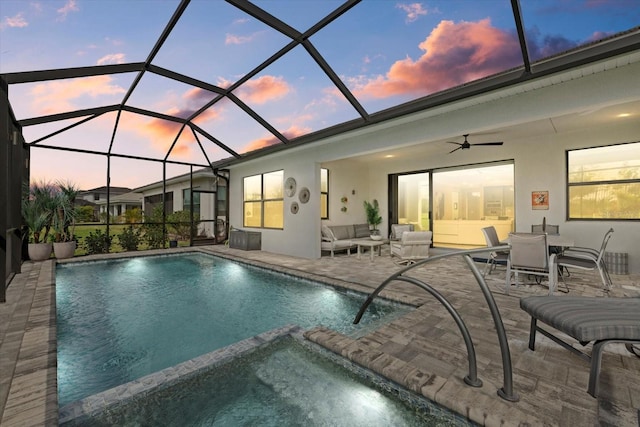 view of swimming pool with a patio, a pool with connected hot tub, a lanai, and an outdoor living space