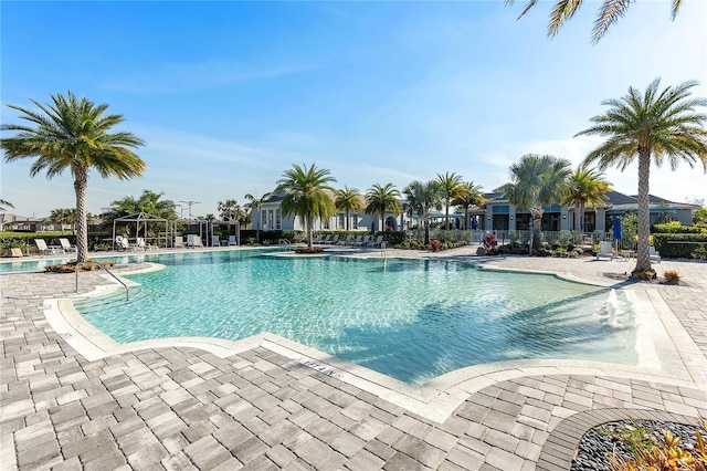 pool with fence and a patio