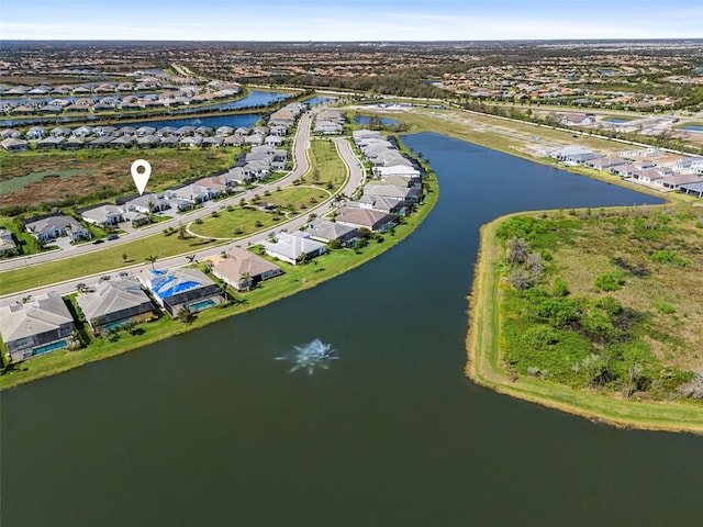 birds eye view of property with a water view and a residential view