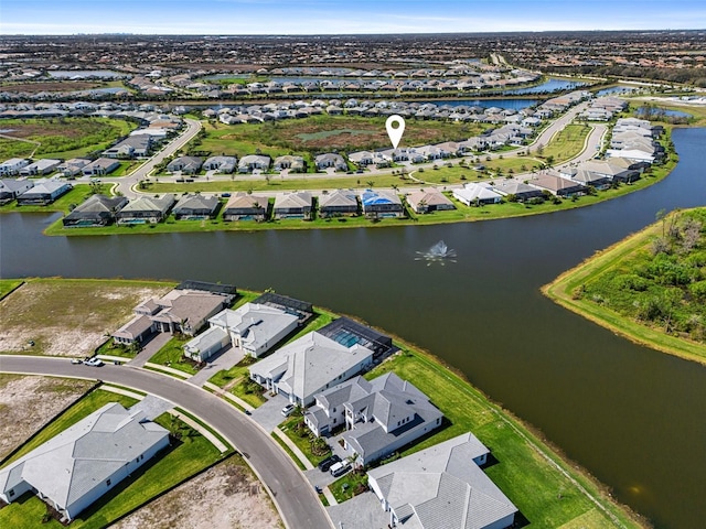 bird's eye view featuring a water view and a residential view