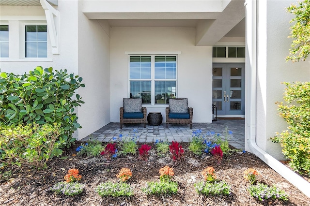 doorway to property with stucco siding and french doors