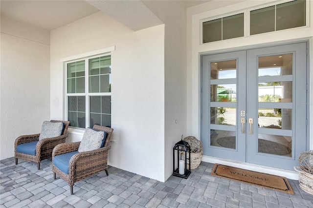 doorway to property featuring stucco siding and french doors