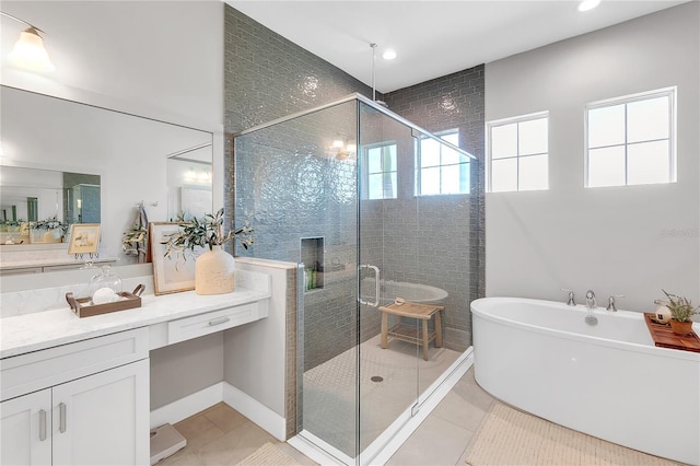 full bathroom with a freestanding tub, tile patterned flooring, vanity, and a shower stall