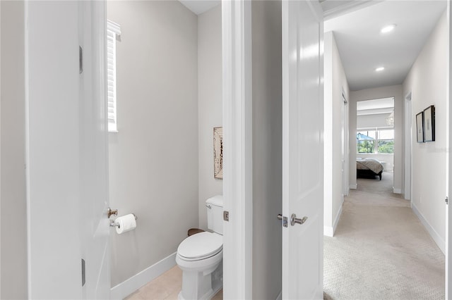 bathroom with recessed lighting, tile patterned flooring, baseboards, and toilet