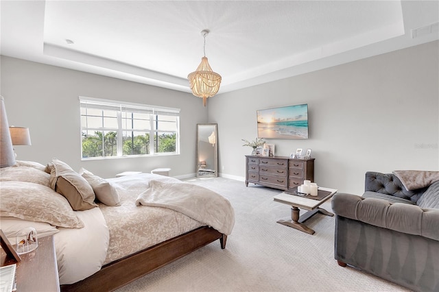 bedroom featuring baseboards, visible vents, a tray ceiling, and carpet flooring