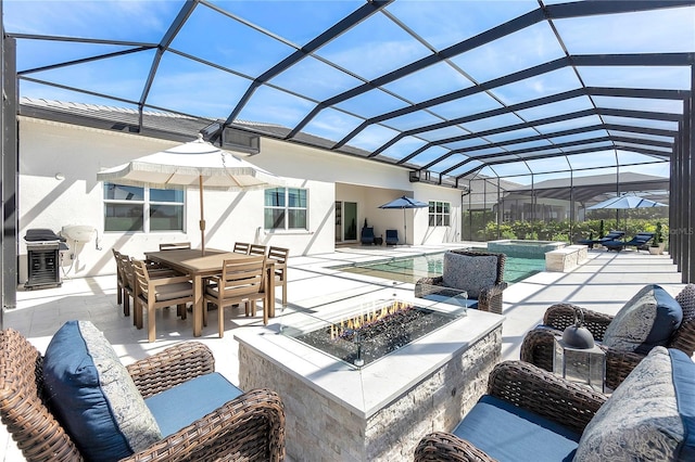 view of patio / terrace featuring glass enclosure, an outdoor fire pit, outdoor dining area, a grill, and a pool with connected hot tub