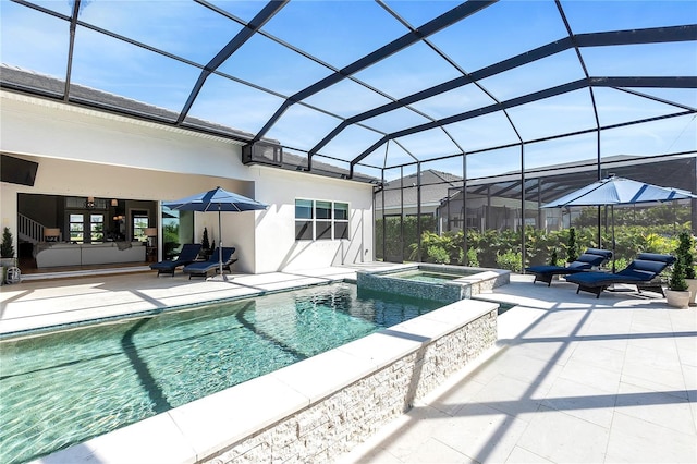 view of pool with glass enclosure, a patio area, and a pool with connected hot tub