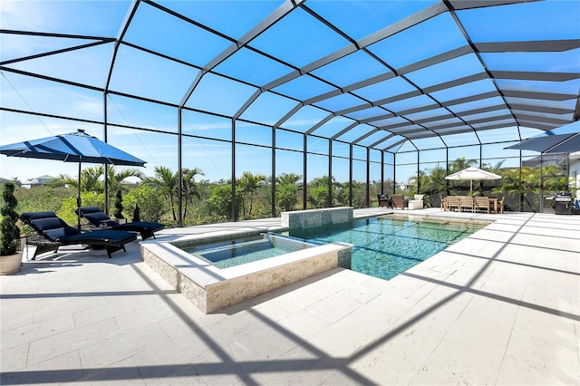 view of swimming pool featuring glass enclosure, a pool with connected hot tub, and a patio