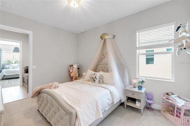 bedroom with visible vents and light colored carpet