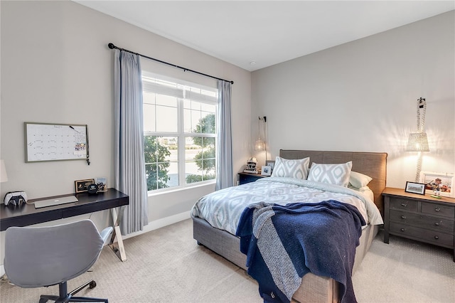 carpeted bedroom featuring baseboards