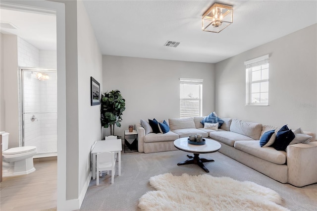 living area featuring a chandelier and visible vents