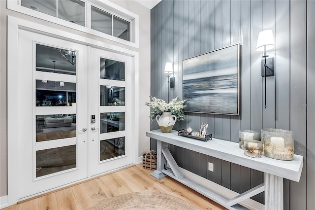 bar with wood finished floors and french doors