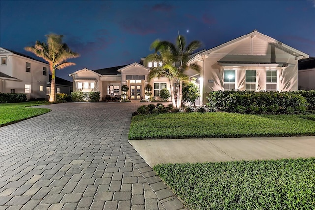 view of front of house featuring a yard and stucco siding